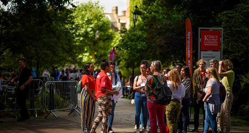 A group of students talking on Guy's campus.