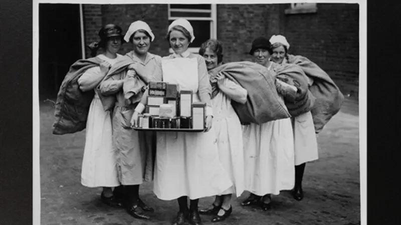 1940 Photograph of a group of Nurses holding sackcloth bags and medical supplies or food